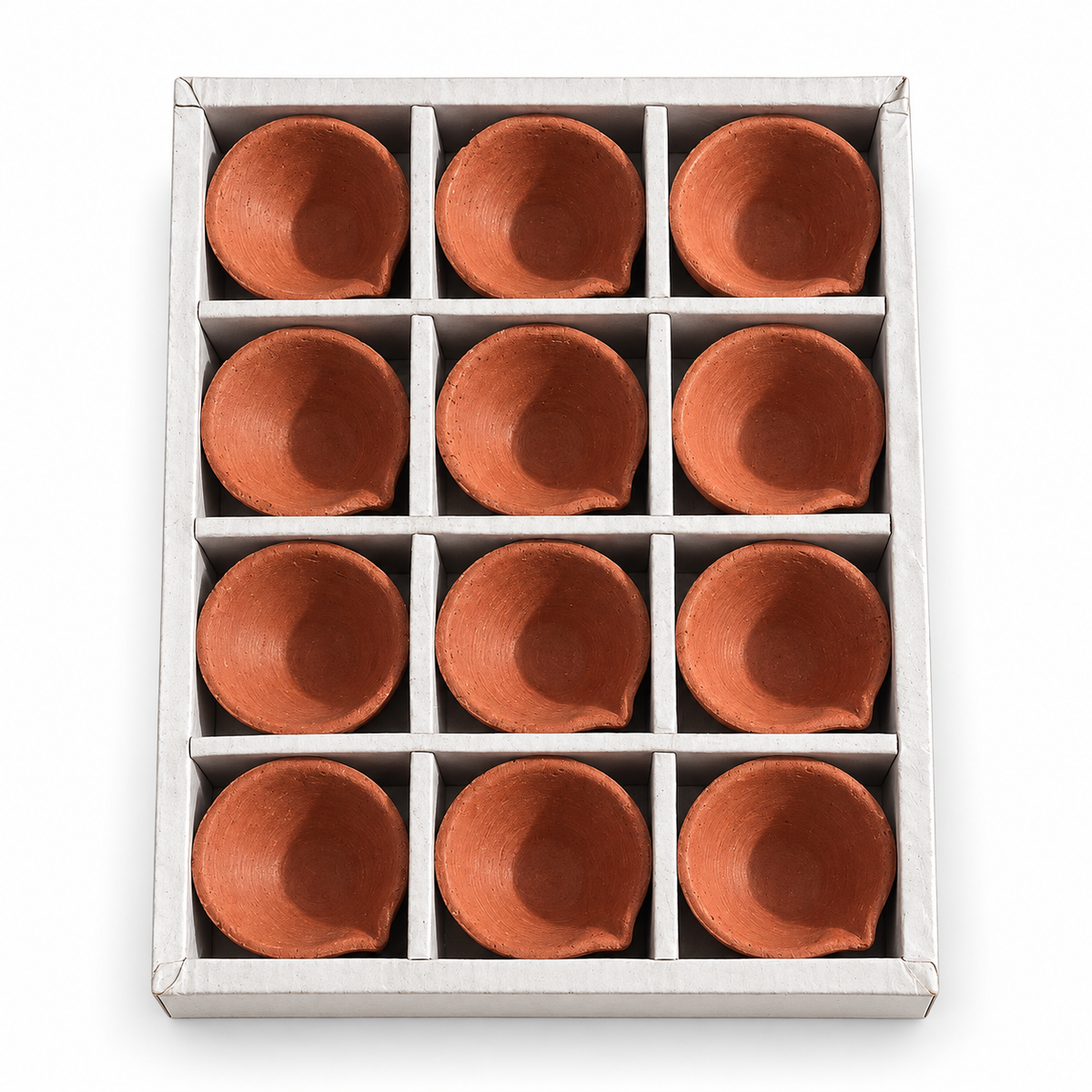 A set of 12 terracotta-colored clay cups arranged in a white cardboard grid tray, photographed from directly above on a white background.